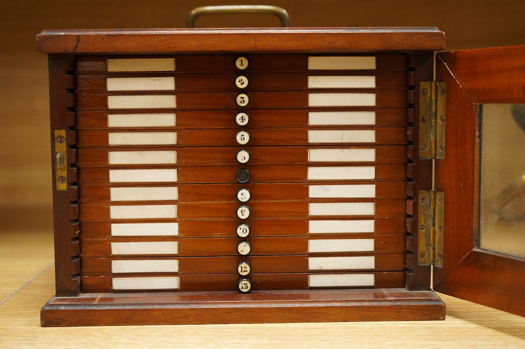 A 19th century mahogany cased slide box, fitted with 13 slide trays, housing approximately 290 slides of mineral, plant, animal and fossil specimens, 26cm wide, 19cm high, 29.5cm deep CITES Submission reference 514GC1XX